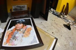 A broken portrait of former Bolivia's President Evo Morales is on the floor of his private home in Cochabamba, Bolivia, after hooded opponents broke into the residence on Nov. 10, 2019.