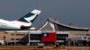 FILE - A Hong Kong Cathay Pacific Airways Airbus passenger plane takes off against the backdrop of a Taiwanese flag, at Taoyuan International Airport, Taiwan, Aug. 6, 2018.