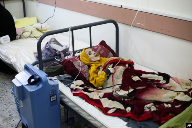 FILE - A 10-year-old Palestinian boy, Yazan al-Kafarna, who was born with cerebral palsy, lies at a hospital in Rafah, March 3, 2024. Yazan died due to what his doctor said was extreme muscle wastage caused primarily by a lack of food. (AP Photo/Hatem Ali, File)