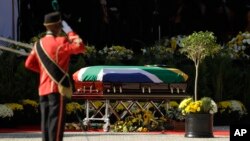 The casket with the remains of Winnie Madikizela-Mandela receives a salute at her funeral service at the Orlando Stadium in Soweto, South Africa, April 14, 2018. Madikizela-Mandela died on April 2 at the age of 81.