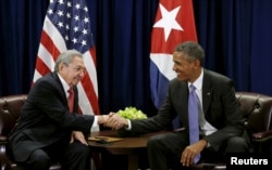 FILE - U.S. President Barack Obama (R) and Cuban President Raul Castro shake hands at the start of their meeting at the United Nations General Assembly in New York September 29, 2015.