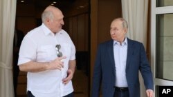 FILE: Russian President Vladimir Putin, right, and Belarusian President Alexander Lukashenko speak during their meeting at the Bocharov Ruchei residence in the resort city of Sochi, Russia, on Fri. June 9, 2023.