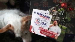 In this Dec. 13, 2019 photo, campaign materials for congressional candidate Bryan Russell sit on a table at his home during an interview in Lima, Peru. (AP Photo/Martin Mejia)