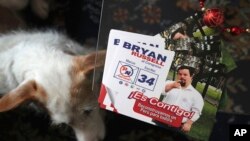 In this Dec. 13, 2019 photo, campaign materials for congressional candidate Bryan Russell sit on a table at his home during an interview in Lima, Peru. (AP Photo/Martin Mejia)