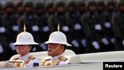 FILE - King Maha Vajiralongkorn and Queen Suthida attend the annual Military Parade to celebrate the Coronation of King Rama X at the Royal Thai Army Cavalry Center in Saraburi province, Thailand, Jan. 18, 2020. 