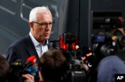 FILE - Presidential candidate Jiri Drahos talks to journalists as he arrives to submit a petition with 142,000 signatures to support his presidential candidacy, at the Ministry of the Interior in Prague, Czech Republic, Nov. 3, 2017.