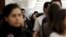 Employees of an office stand ready to evacuate the building after a tremor was felt in Mexico City, Nov. 23, 2015. 