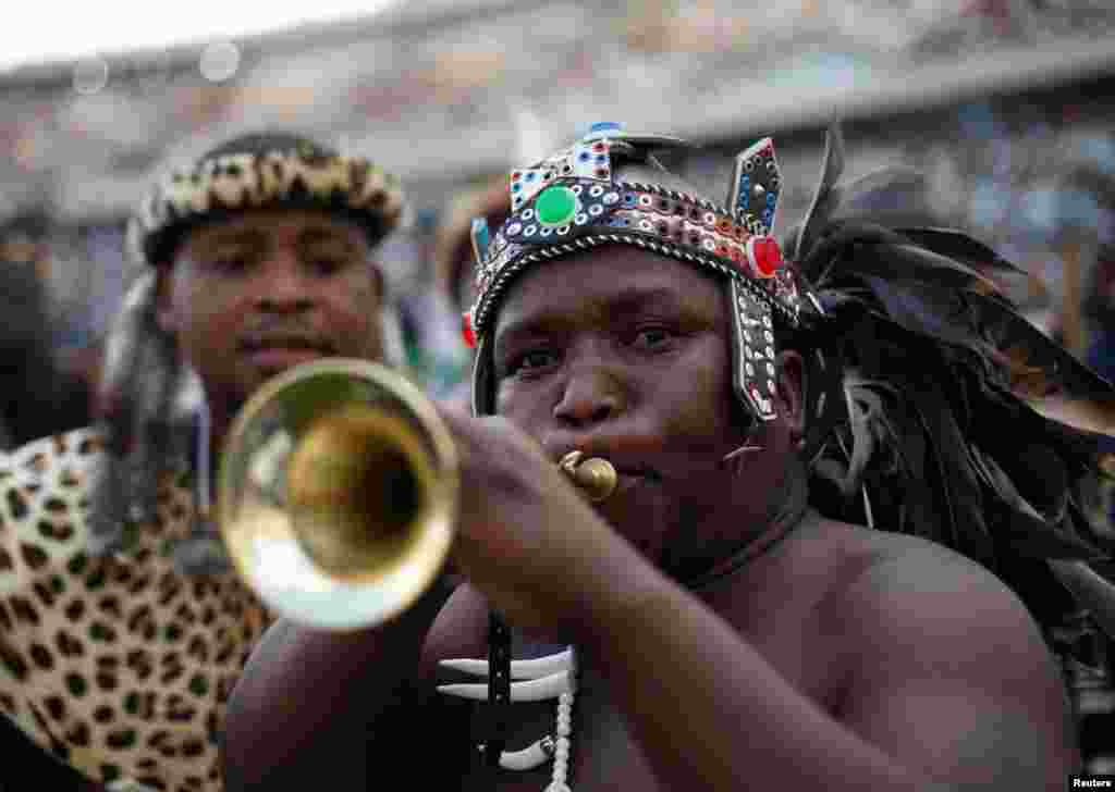 A supporter of new AmaZulu King Misuzulu kaZwelithini blows a trumpet during the final ceremony of his coronation, in Durban, South Africa, October 29, 2022.&nbsp;