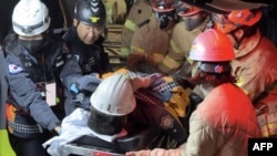 This photo taken Nov. 4, 2022, and provided by the Gyeongbuk fire service headquarters via Yonhap news agency shows a miner being rescued from a collapsed zinc mine in the county of Bonghwa, southeast of Seoul. 