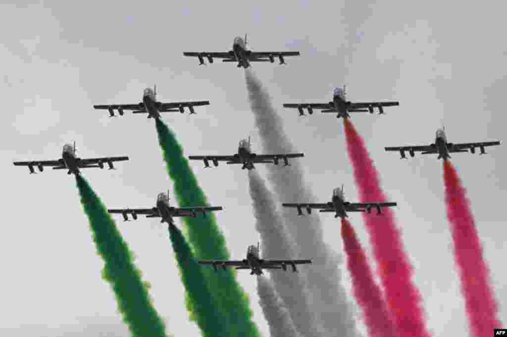 Planes of the Italian Air Force aerobatic unit Frecce Tricolori (Tricolor Arrows) spread smoke with the colors of the Italian flag as they fly over Rome as part of celebrations of National Unity and Armed Forces Day, marking the end of the World War I in Italy.