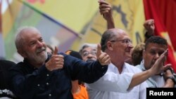 El entonces candidato presidencial Luis Inácio Lula da Silva, junto a su compañero de fórmula Geraldo Alckmin, levantan el pulgar durante una marcha en Porto Alegre, Brasil, el 19 de octubre de 2022.