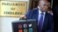 Chinamasa is shown in this meme displaying a big briefcase outside parliament. Check what's inscribed on the briefcase.