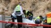Petugas medis dan keamanan Israel memeriksa lokasi serangan di Zona Industri Ariel di Tepi Barat yang diduduki, 15 November 2022. Dua warga Israel dilaporkan tewas dalam insiden tersebut. (GIL COHEN-MAGEN / AFP)