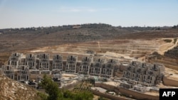 FILE - General view of a construction site in the Israeli settlement of Givat Zeev in the occupied West Bank north of Jerusalem, July 31, 2019.