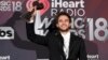 Zedd poses in the press room with the award for dance song of the year for "Stay" at the iHeartRadio Music Awards at The Forum in Inglewood, Calif., March 11, 2018.