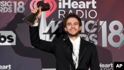 Zedd poses in the press room with the award for dance song of the year for "Stay" at the iHeartRadio Music Awards at The Forum in Inglewood, Calif., March 11, 2018.