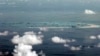 This photo taken through a window of a military plane shows China's apparent reclamation of Mischief Reef in the Spratly Islands in the South China Sea, May 11, 2015.