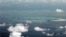 FILE - This photo taken through a window of a military plane shows China's apparent reclamation of Mischief Reef in the Spratly Islands in the South China Sea, May 11, 2015.