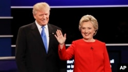 FILE- Republican presidential nominee Donald Trump and Democratic presidential nominee Hillary Clinton are introduced during the first presidential debate at Hofstra University in Hempstead, N.Y., Sept. 26, 2016. 