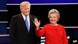 FILE- Republican presidential nominee Donald Trump and Democratic presidential nominee Hillary Clinton are introduced during the first presidential debate at Hofstra University in Hempstead, N.Y., Sept. 26, 2016. 