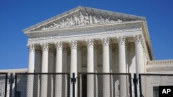 Security fencing surrounds the Supreme Court building on Capitol Hill in Washington, Sunday, March 21, 2021. (AP Photo/Patrick Semansky)