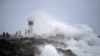 Waves crash onto rocks as people look on at the Spit, on the Seaway on the Gold Coast, Australia, March 3, 2025, as Cyclone Alfred builds off the east coast.