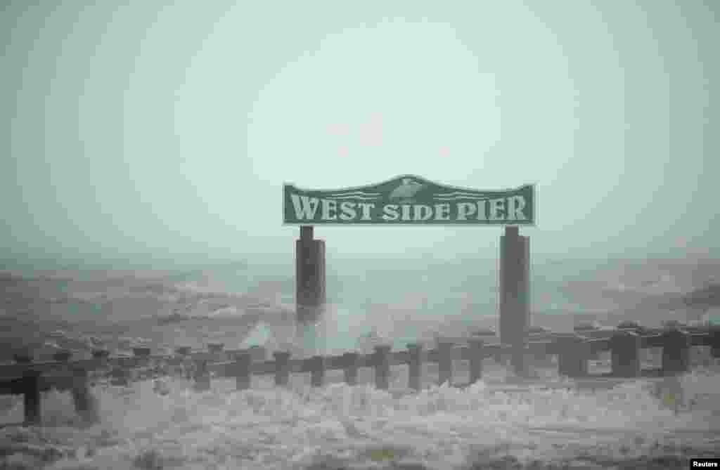 The surf washes over the West Side Pier as Hurricane Isaac passes through Gulfport, Mississippi, August 29, 2012.