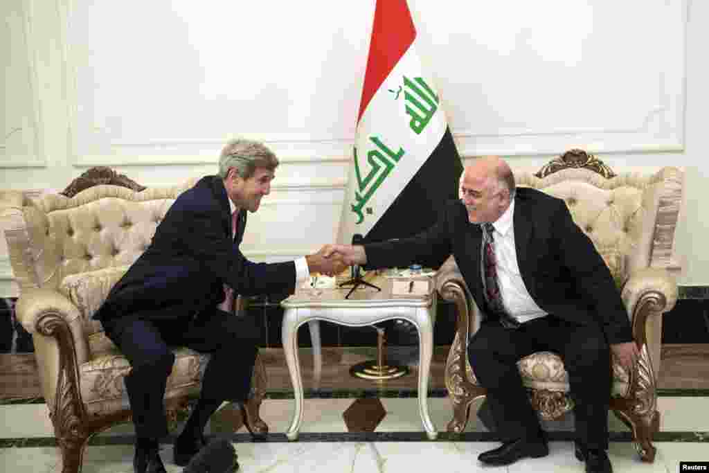 U.S. Secretary of State John Kerry, left, and new Iraqi Prime Minister Haider al-Abadi shake hands after a meeting in Baghdad Sept. 10, 2014. 