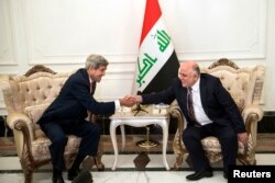 U.S. Secretary of State John Kerry, left, and new Iraqi Prime Minister Haider al-Abadi shake hands after a meeting in Baghdad Sept. 10, 2014.