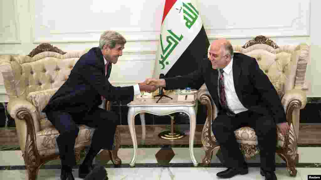 U.S. Secretary of State John Kerry, left, and new Iraqi Prime Minister Haider al-Abadi shake hands after a meeting in Baghdad Sept. 10, 2014. 