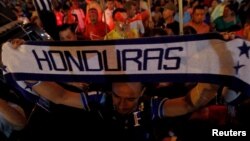 A demonstrator holds up a scarf during a march to demand the resignation of Honduras' President Juan Orlando Hernandez in Tegucigalpa, Sept. 11, 2015. 