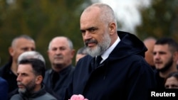 Albania's Prime Minister Edi Rama attends the funeral of six members of the Cara family, killed during an earthquake that shook Albania, in Thumane, Albania, Nov. 29, 2019. 