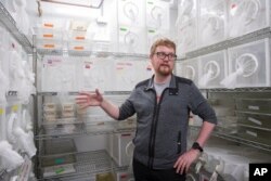 FILE - Researcher Ben Matthews speaks in a room housing mosquitoes in the Vosshall Laboratory at Rockefeller University in New York, Feb. 12, 2019.