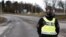A police officer wearing a gas mask stands guard at the scene after emergency services were alerted to Sweden's Security Service headquarters in Solna, north of Stockholm, because of a suspected gas leak on Feb. 23, 2024.