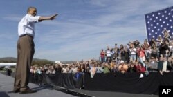 President Barack Obama speaks at Asheville Regional Airport in Fletcher, N.C., to begin his three-day bus tour promoting the American Jobs Act, October 17, 2011.