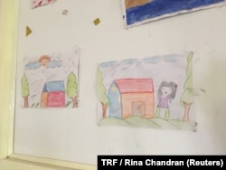 FILE - Drawings by children are displayed on the wall of a shelter for homeless women in New Delhi, July 4, 2018.