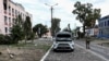 FILE - A Ukrainian serviceman patrols a street next to buildings damaged during fighting between Ukrainian and Russian forces in the Ukrainian-controlled town of Sudzha in Russia's Kursk region, Aug. 16, 2024. 