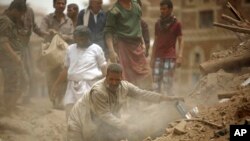 People search for survivors under the rubble of houses destroyed by Saudi airstrikes in the old city of Sana'a, Yemen, June 12, 2015. 