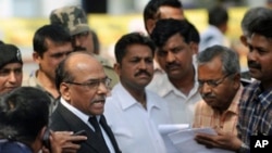 Public Prosecutor Rajendra Tiwari (L) addresses media representatives following the verdict on the 2002 Godhra train incident at the special court inside the Sabarmati Central Jail in Ahmedabad