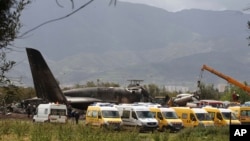 Firefighters and civil security officers work at the scene of a fatal military plane crash in Boufarik, near the Algerian capital, Algiers, Apr. 11, 2018. 