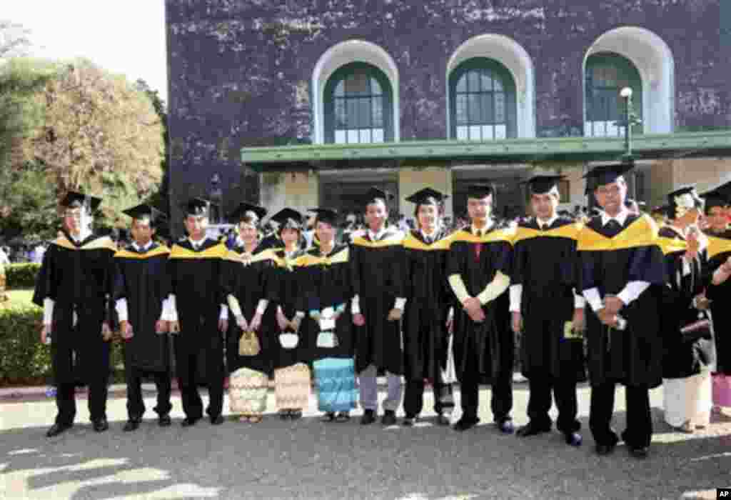 In this photo taken on April 5, 2008, graduated students pose for photos outside the convocation hall in the main campus of Yangon University in Yangon, Myanmar. The university was once one of Asia's finest and a poignant symbol of an education system cri