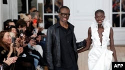 FILE - Cameroonian designer Imane Ayissi (L) at the presentation of his creations during the Women's Haute-Couture Spring/Summer 2024 Fashion Week in Paris on January 22, 2024. 