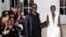 FILE - Cameroonian designer Imane Ayissi (L) at the presentation of his creations during the Women's Haute-Couture Spring/Summer 2024 Fashion Week in Paris on January 22, 2024. 