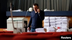 Roman Lyagin, leader of the separatist republic's election commission, talks on a mobile phone at the commission headquarters in Donetsk, eastern Ukraine, May 8, 2014. 