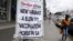 A woman walks past newspaper billboards during the coronavirus disease outbreak in Johannesburg, South Africa, Feb. 8, 2021. 