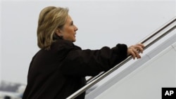 Secretary of State Hillary Clinton boards her plane for a trip to Haiti at Andrews Air Force Base outside of Washington, DC, January 30, 2011