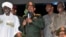 Sudan's President Omar al-Bashir (C) addresses supporters after the army announced it had seized back the town of Abu Kershola from the Sudanese Revolutionary Front, outside the military headquarters in Khartoum, May 27, 2013.