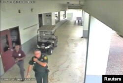 FILE - Then-Broward County Sheriff's Deputy Scot Peterson, who was assigned to Marjory Stoneman Douglas High School during the February 14, 2018 shooting, is seen in this still image captured from the school surveillance video released by Broward County Sheriff's Office in Florida, on March 15, 2018.