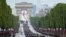 Troops walk down the Champs-Elysees avenue during the Bastille Day parade in Paris, France, July 14, 2021.