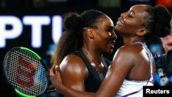 Serena Williams embraces her sister after winning her women's singles final match against Venus Williams.